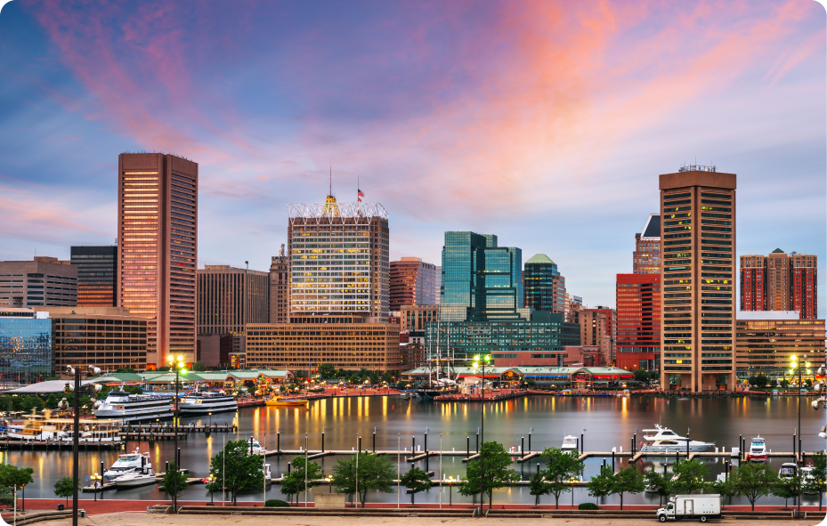 Scenic city harbor skyline at sunset with docked boats