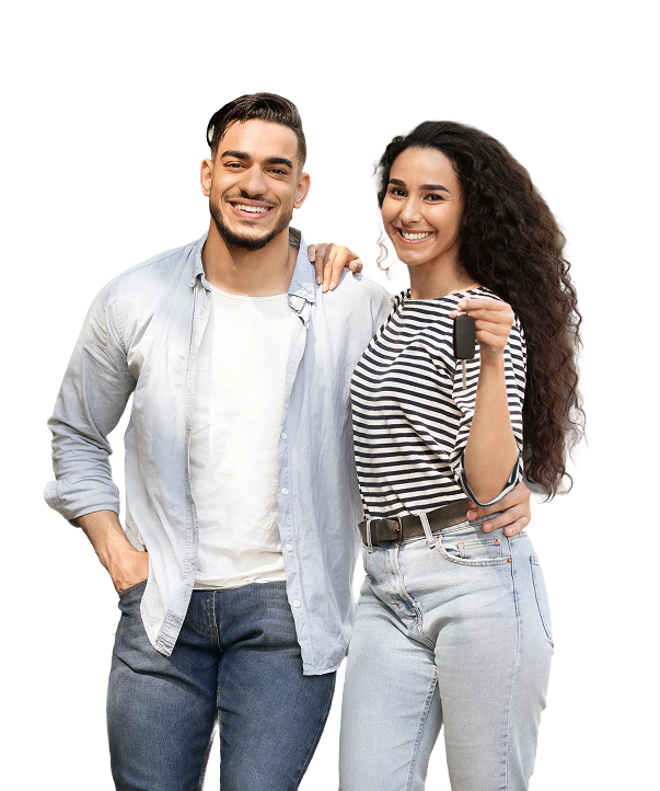 Happy young couple holding up a car key