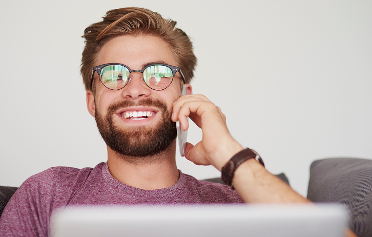 Smiling man calling someone